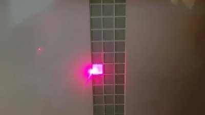 Laser pointer lighting up the glass tiles