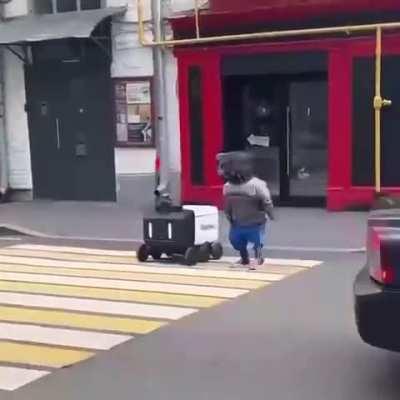 Cyberpunk is here: a robot in clothes moved a delivery bot across the road