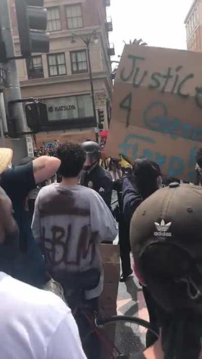 Cop fires in to a crowd of peaceful protestors in Hollywood today. (This is my video)