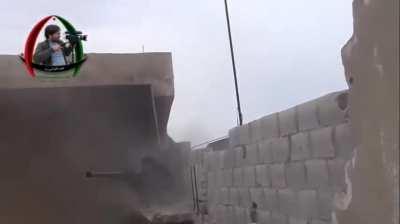 FSA fighter goes out on a ledge to engage an SAA checkpoint using a M-79 OSA - al-Manshiya, Daraa - 12/3/2013