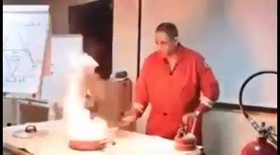 Firefighter demonstrating how to properly put out a pan fire