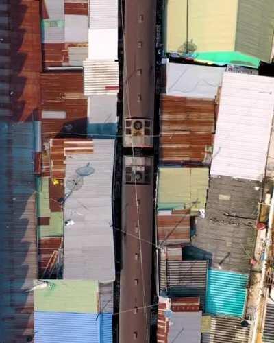 The way that this train passes through a market in Maeklong, Bangkok.