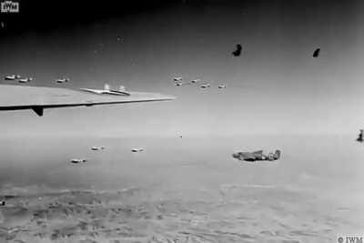 USAAF B-25 Mitchell bombers flying thru flak, most likely Italy 1943-44.