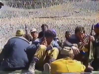 Armenian occupants taking Azerbaijani child hostage. His mother(or grandmother) is begging the occupants to take her with the child. They’re telling her to go away. Occupation of Kalbajar, 1993