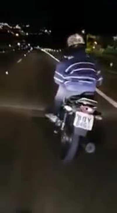 Motorcycle rider trying to do wheelies