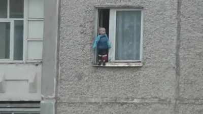 Russian kid checks out the view from his window