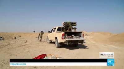 Kurdish fighter uses lighter and a fuse to launch rockets (Unknown date and location).