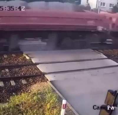 Car tries to beat train