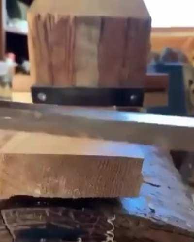 Sharp knife smoothly slicing wood