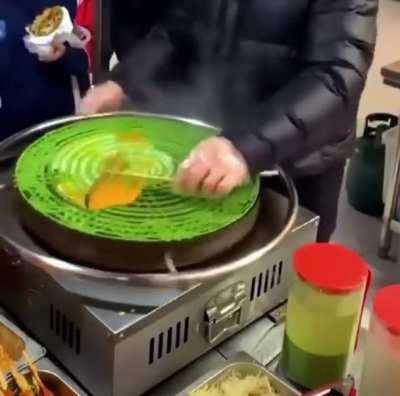 Making street food with a spinning grill