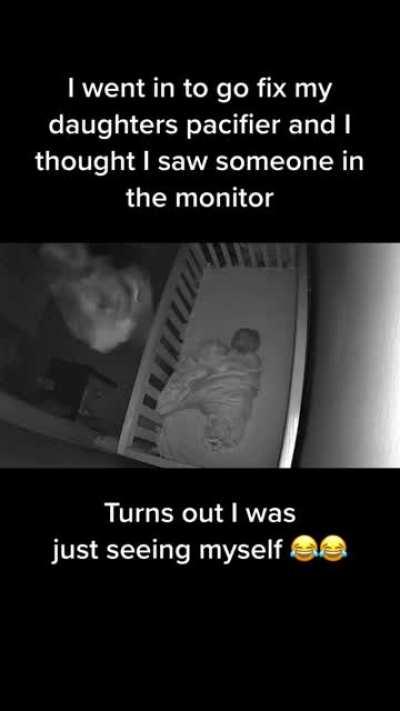 The mom got scared by herself thinking she saw someone else on the monitor