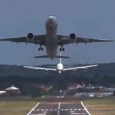 A passenger jet getting airborne 10 seconds before the plane landing behind it touches down