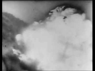 An RAF Spitfire, flying from Sicily, attacks a train marshalling yard in Italy in 1943 and denotes a load of ammunition. Unfortunately, the aircraft just ahead (middle left) is caught in the blast and is destroyed.