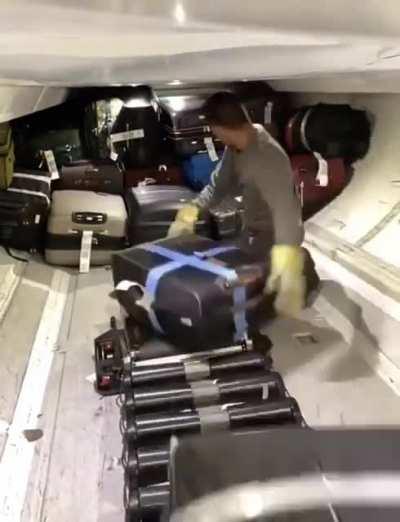 Packing a plane with luggage.