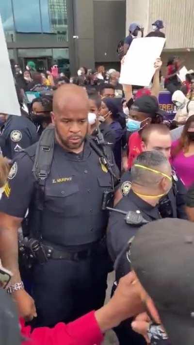 This Police Officer speaking to a group of protesters about their right to protest