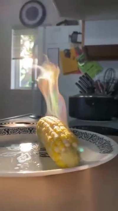 The camera captured the light reflecting off the water droplets of the steam at the right angle to make Magical Corn.