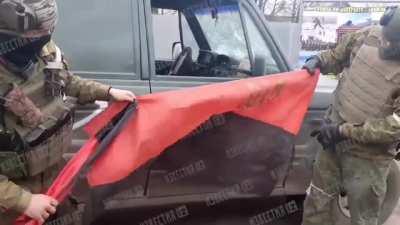 Russian operators pose with captured flags