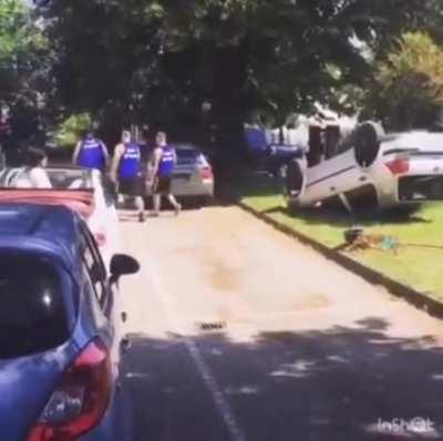 Good Samaritans help to un-flip toppled cars after hurricane