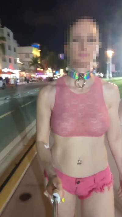 A very public walk with a submissive collar, a sheer crop top, and micro shorts.