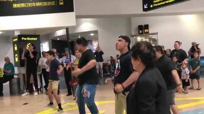 Maori family greets their siblings at the airport in a cultural way.