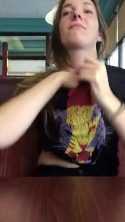 Shy and quiet girl pulls off her bra and flashes her tits in a diner.