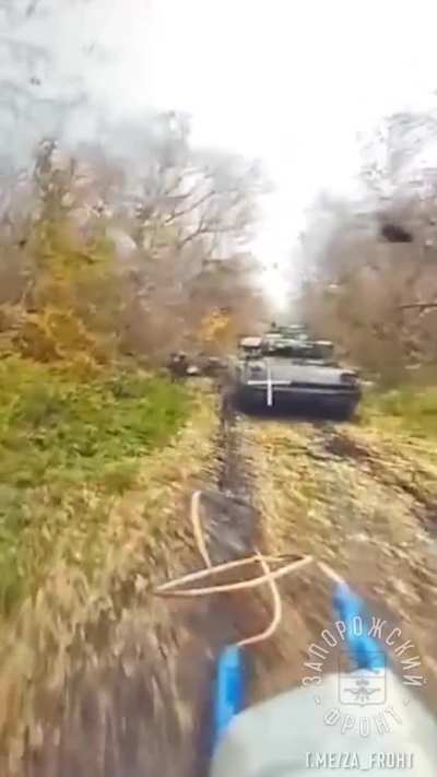 Russian FPV drone sneaks up on a group of Ukrainian soldiers and a Bradley in Kursk oblast