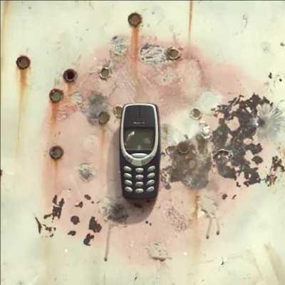 Nokia 3310 phone is shot by a bullet.