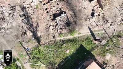 Two Russian soldiers standing still to avoid drone detection and getting hit anyway (1st Assault Battalion)