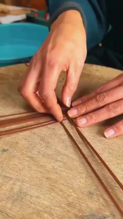 A Japanese artisan crafting a suitcase from a single bamboo culm, cloth and pieces of leather