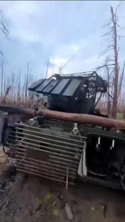 A Ukrainian soldier inspects the destroyed Russian BMP-2M 