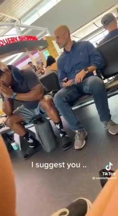 Bro gets upset when someone sits next to him at the airport terminal.