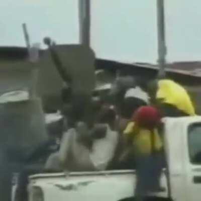 A technical packed with militiamen is hit by accurate return gunfire in Liberia.