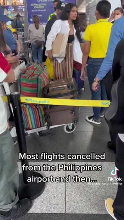 Flights cancelled from the Philippines due to poor weather, person loses it at airline workers who have no control over weather conditions.