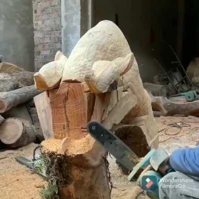 Carving a wooden bull