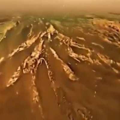 Huygens probe descending on the surface of the Titan, this landing on the Saturn's largest moon was possible because of NASA's Cassini probe..