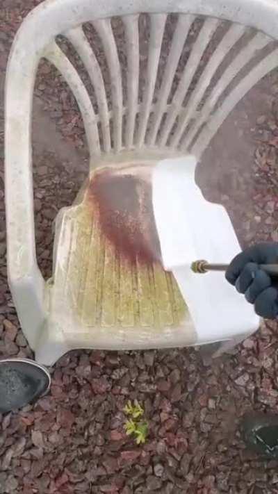 Powerwashing a dirty plastic chair