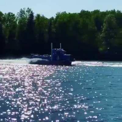 A semi truck that looks like it's driving on the water.