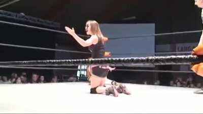 Miss Mina experiencing the dropkick low blow by Britani Knight