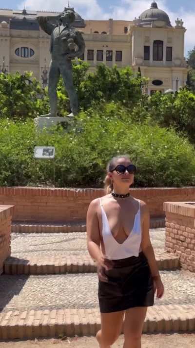 Braless Thot walking through the city.