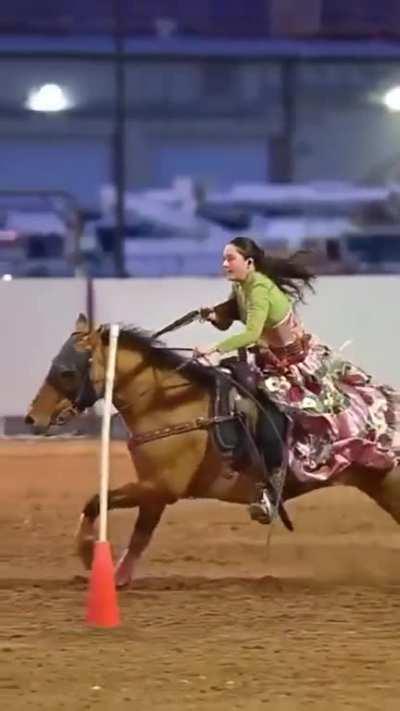 Girl hitting targets while riding a horse wild west style