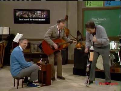 Mister Rogers in 1986, having a lot of fun playing music with Joe Negri on guitar and Bob Rawsthorne on stumpf fiddle