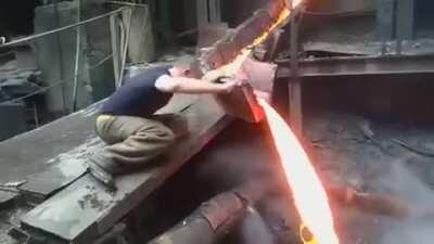 Russian men put his hand in molten metal