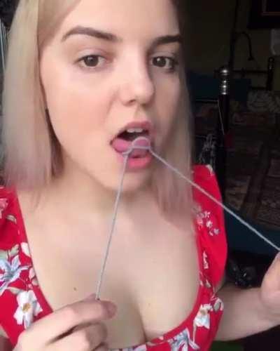 Making a knot with her tongue