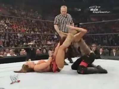 Lita stomps Mickie downstairs and headbutts her for good measure