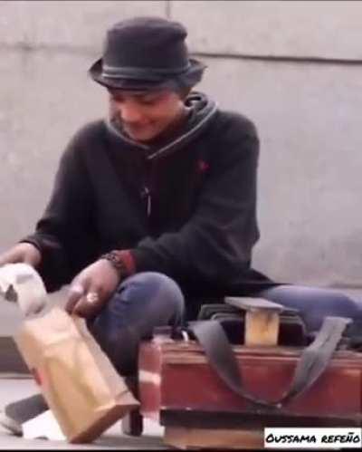 Kid on the street gets given a burger.