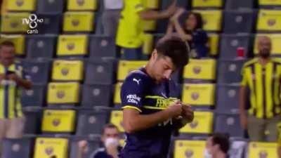 Muhammed Gumuskaya tries to celebrate by kissing the Fenerbahce badge on his Puma kit...