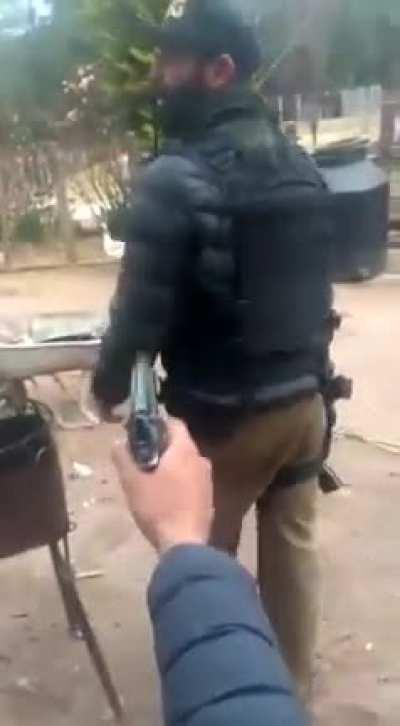 Sicarios test out plate carrier with Beretta M9 en un rancho in Sinaloa, México.