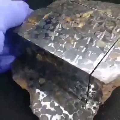 This came from space. A metallic meteorite made up of iron-nickel and olivine crystals! Amazing!