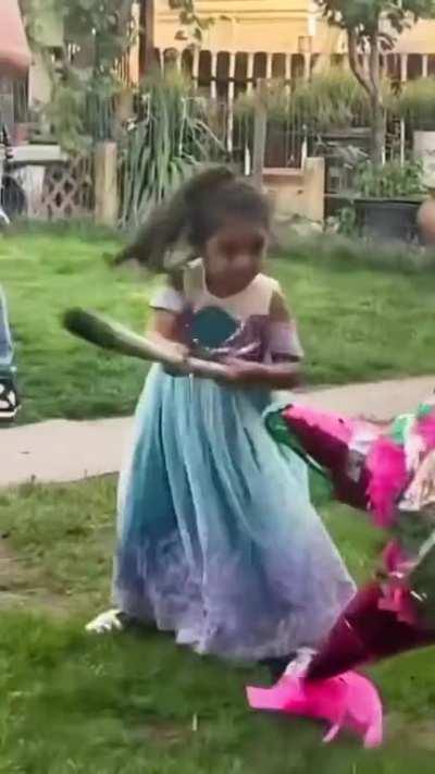 A girl swinging a bat at a piñata