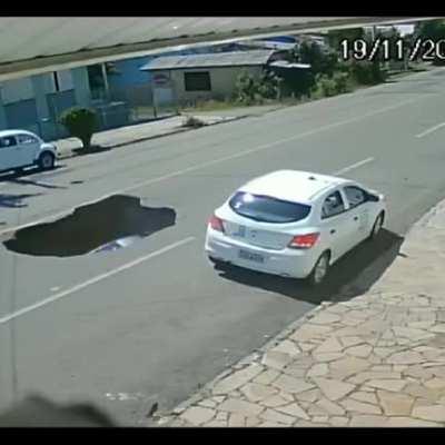 Car drives into sinkhole